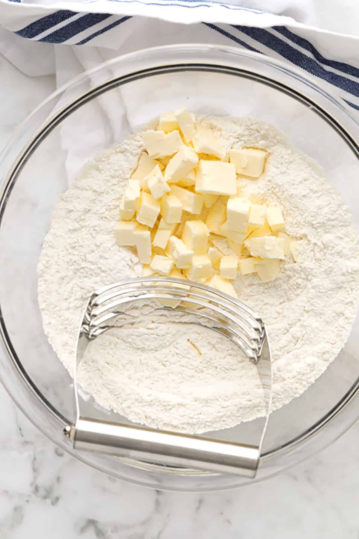 These homemade biscuits are flaky, fresh and so easy to make! Warm from the oven, these are delicious served with a homemade chicken and gravy meal, as a side dish with soup, or even for breakfast with jam! #homemadebiscuits #fromscratch #homemade #biscuits #spendwithpennies butter and flour in a bowl to make Homemade Biscuits