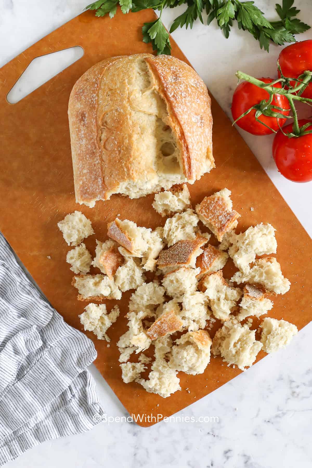 torn bread on a cutting board for panzanella salad