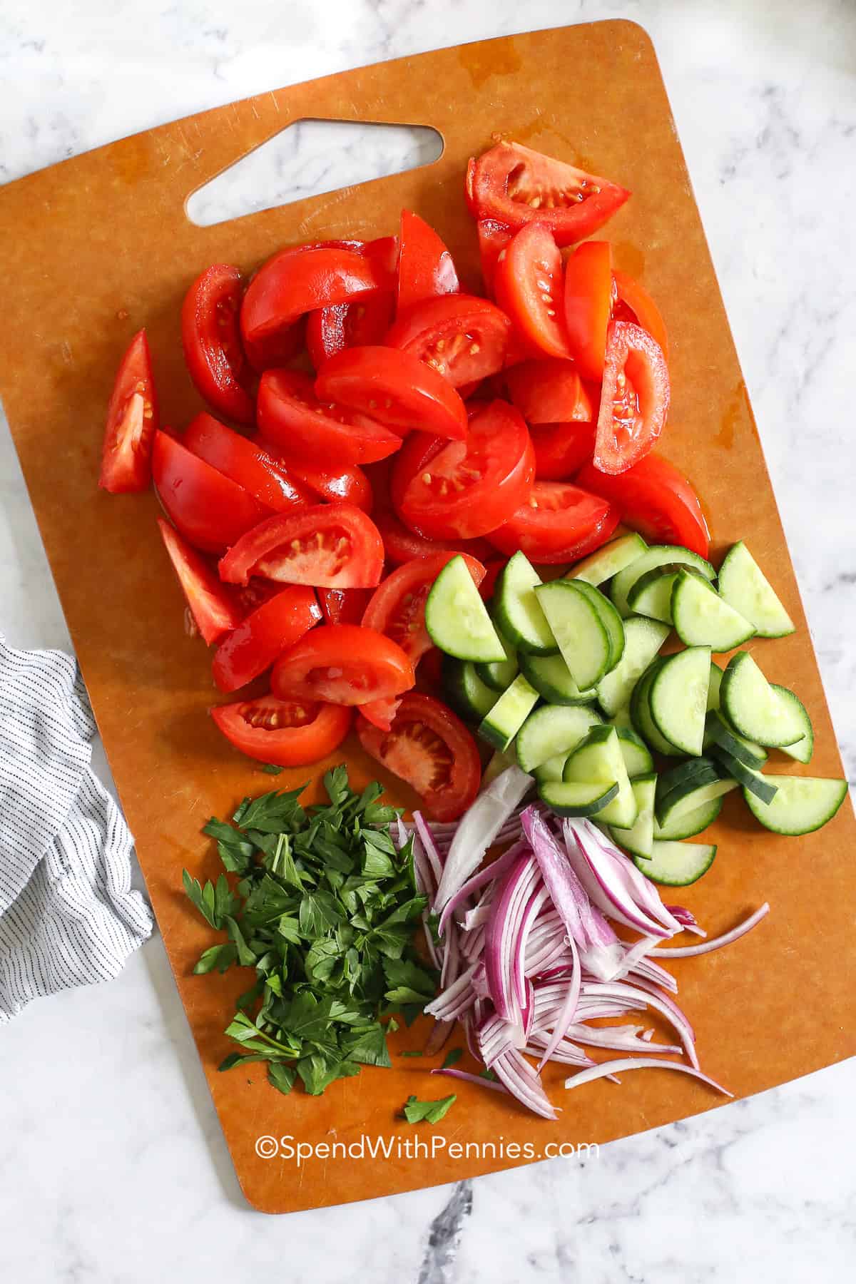 cut vegetables on a cutting board for panzanella salad