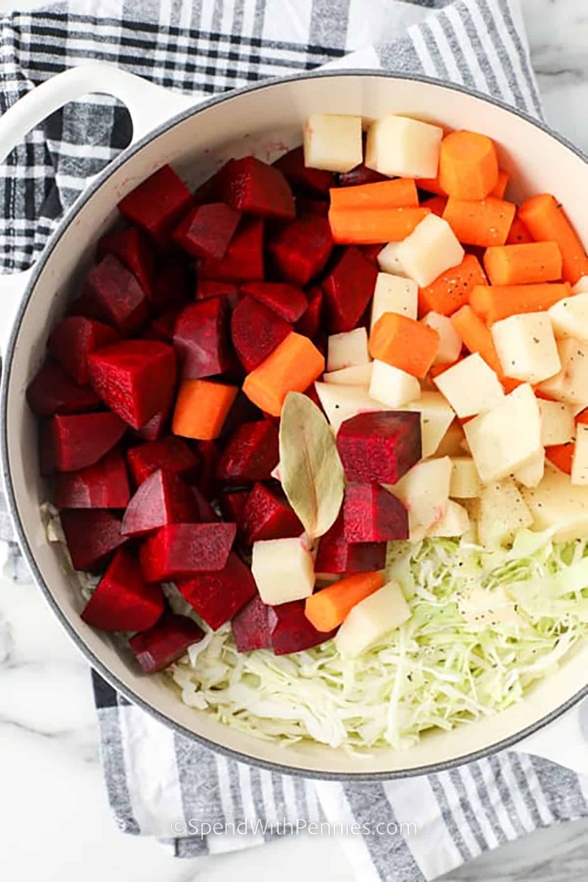 Borscht is a traditional soup recipe made with ingredients like cabbage, beets, and garnished with sour cream and dill! This easy and delicious soup is even better the next day so be sure to make lots! #borscht #soup #homemade #beetsoup #spendwithpennies ingredients to make Borscht in a pot