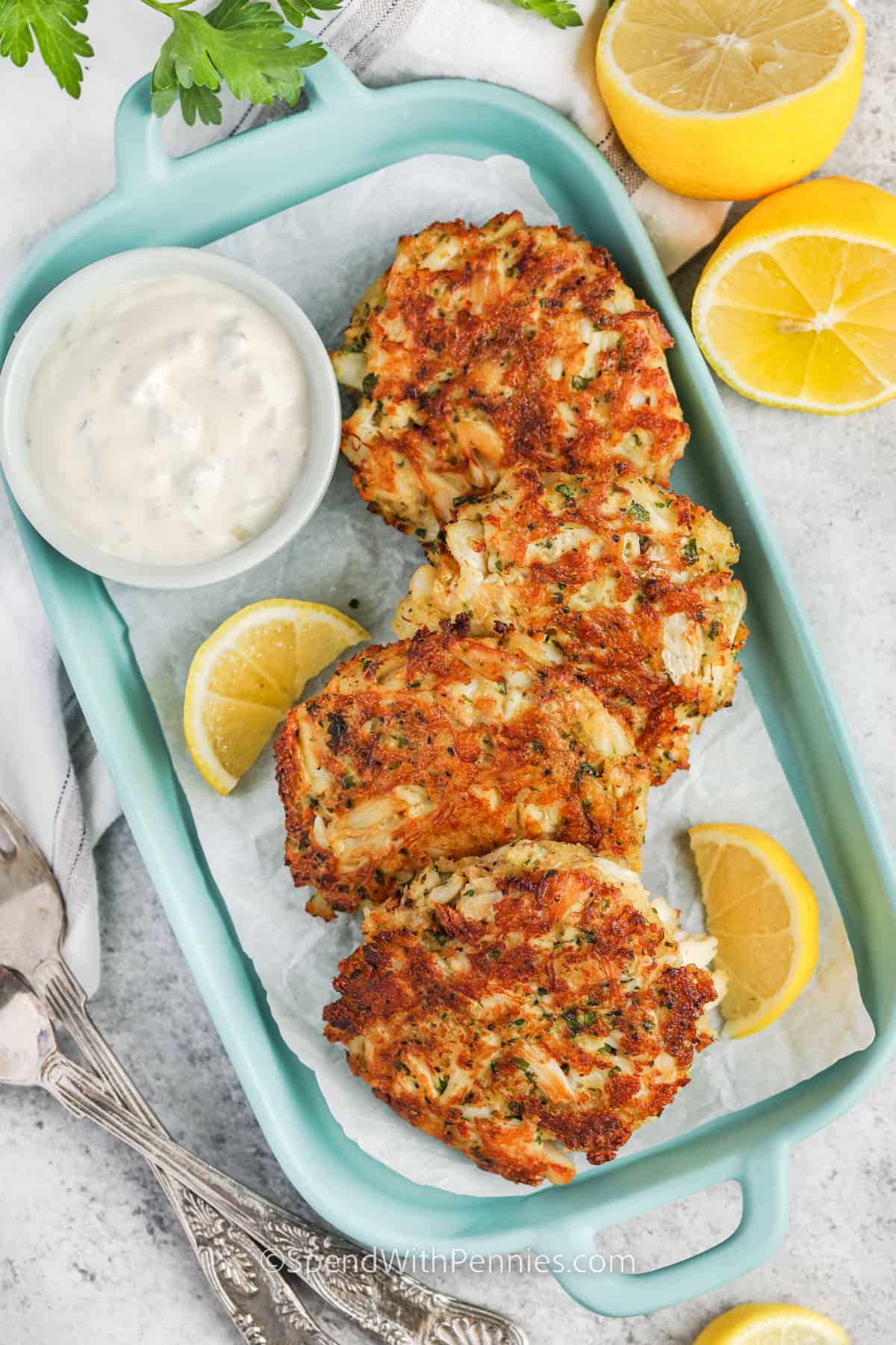 Easy Crab Cakes on a blue dish with lemon wedges