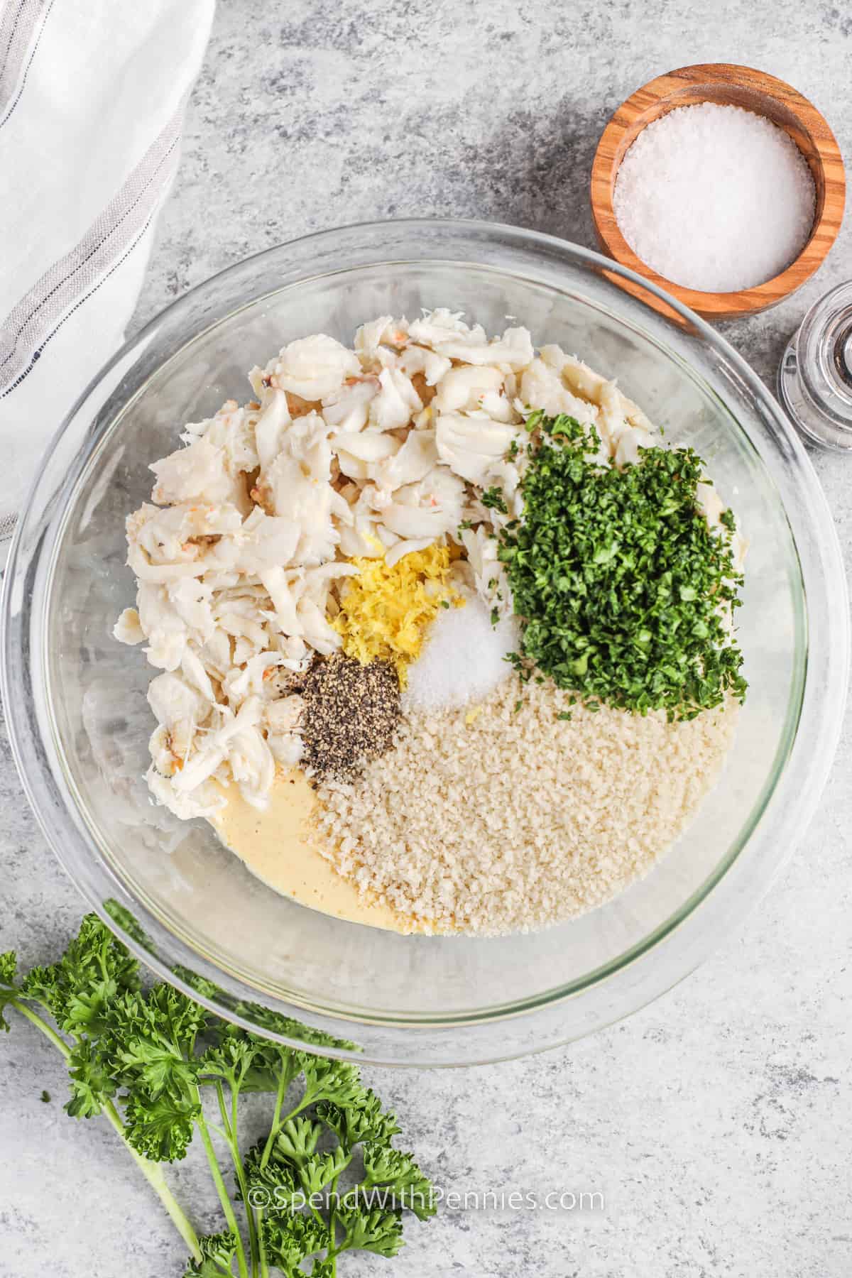 adding crab and other seasonings with panko to bowl to make Easy Crab Cakes