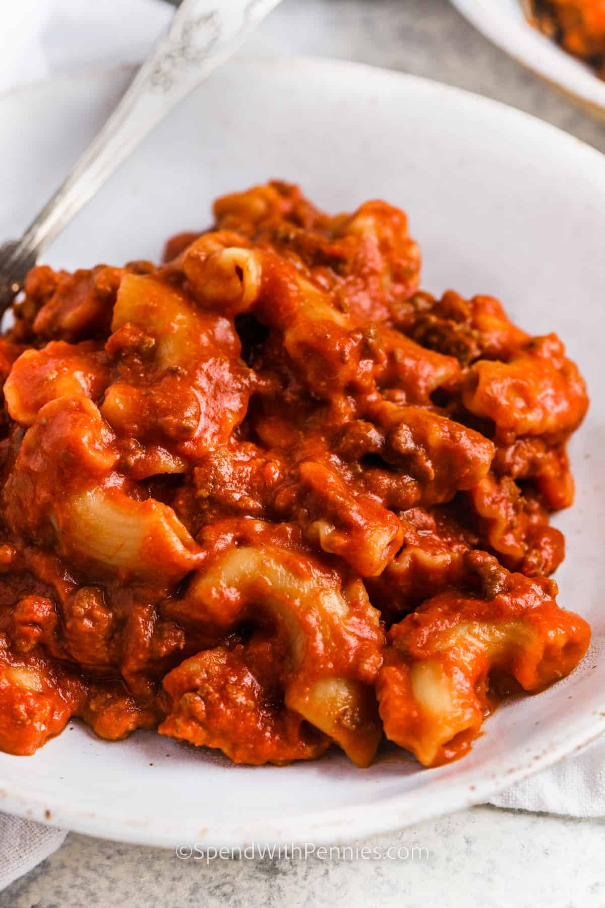 Homemade beefaroni is a hearty, savory one-skillet meal that takes only minutes to prep and cook and is much healthier than Chef Boyardee from a can. Ground beef is browned in a skillet, then combined with canned tomatoes, macaroni, and seasonings, and cooked until tender. Stir in shredded cheddar at the end, or leave it out and save some calories! #beefaroni #beefaronirecipe #homemade #spendwithpennies close up of Homemade Beefaroni