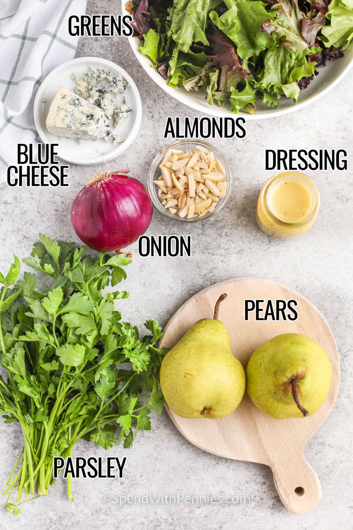 Add a fresh and fruity twist to your dinner with this simple pear salad. Toss crispy greens with sweet pears, crunchy almonds, and creamy blue cheese or feta. The tangy dressing with a touch of maple syrup ties everything together. You can easily switch up the ingredients. Use arugula, spinach, apples, walnuts, gorgonzola, or goat cheese. It’s a flavor-packed side dish that’s sure to impress! #spendwithpennies ingredients to make pear salad labeled