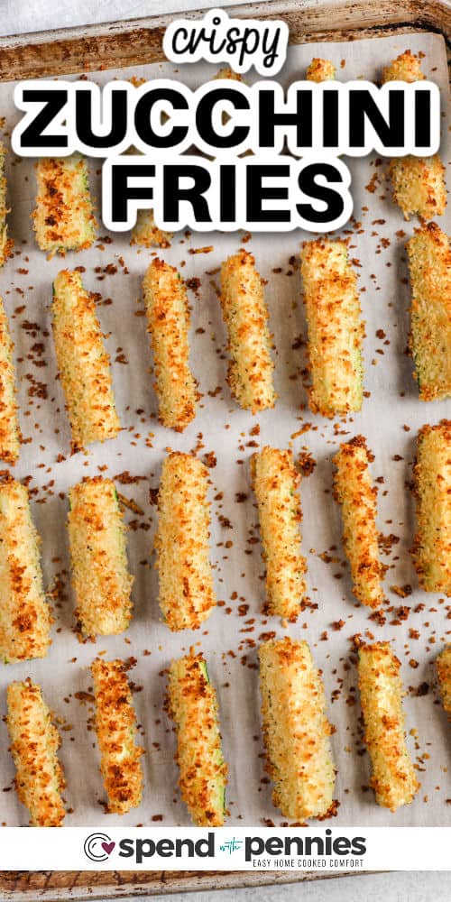 Crispy and delicious zucchini fries are easy and fun to make! Use up that garden bounty with this easy recipe for baked zucchini fries. With less oil than deep frying, but just as delicious and flavorful, oven-baked zucchini fries are a surefire hit. Try making these with a low-carb keto batter, instead of Panko breadcrumbs, or stick with the recipe and enjoy the crispy goodness of homemade zucchini fries! #zucchinifries #crispyzucchinifries #bakedzucchinifries #spendwithpennies baked Crispy Zucchini Fries on a sheet pan with a title