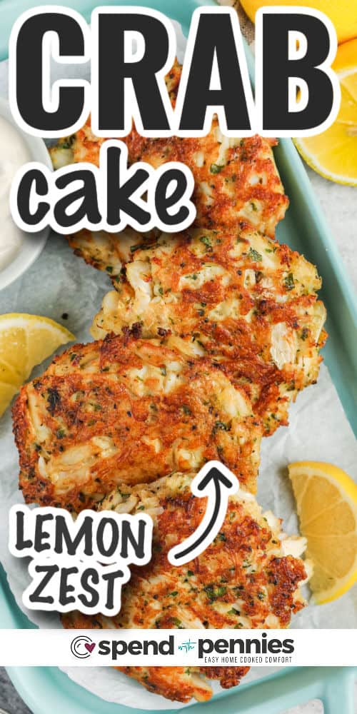 This easy crab cakes recipe is loaded with flavor and turns out crispy and delish. Simple ingredients including Worcestershire sauce, lemon zest, mayonnaise, and Old Bay seasoning, plus fresh herbs and Panko make the best crispy pan-fried crab cakes ever. These won't take long to make, and they taste great served as an appetizer or a sandwich for the perfect lunch! #crabcakes #crabcakesrecipe #crabcake #spendwithpennies plated Easy Crab Cakes with lemon slices and writing