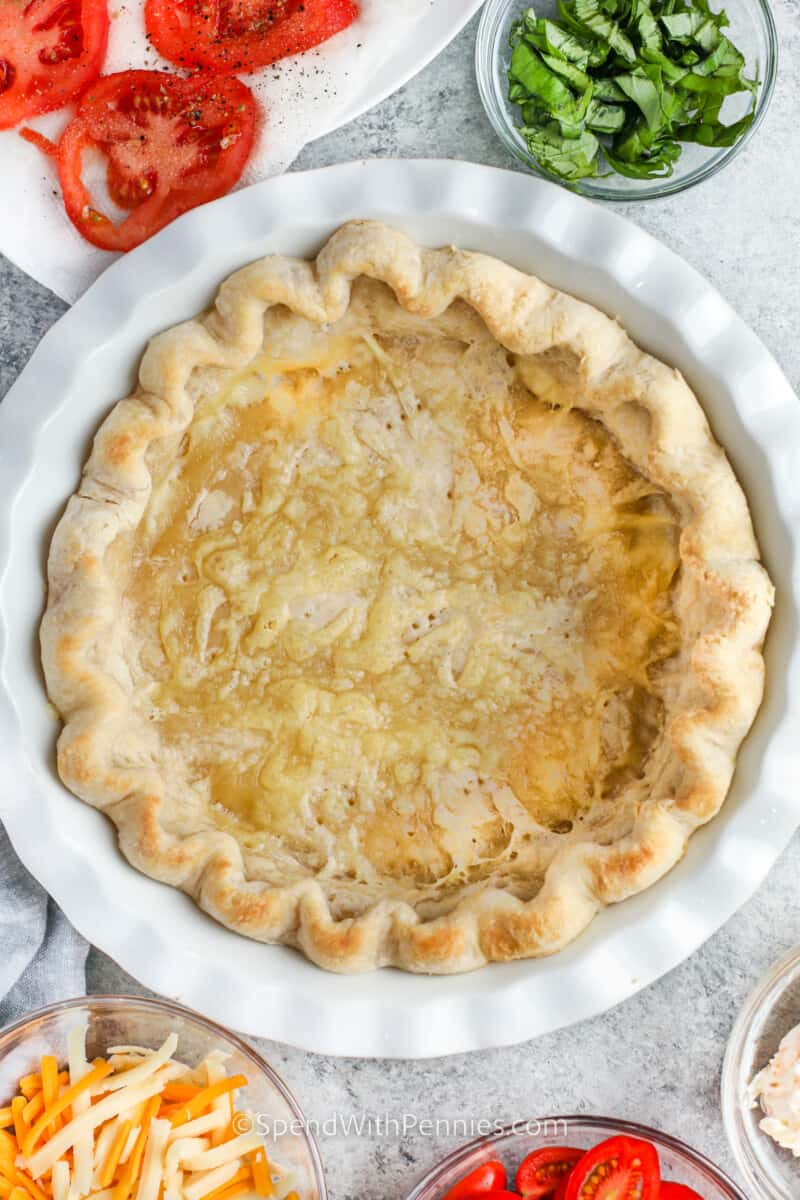 One of the best things about tomato pie is that you can make it ahead and serve it cold! Or you can prepare it to serve as a vegetarian dinner. Have it warm or at room temperature, it always tastes delish. Kids love it because it tastes like pizza, and adults love the fresh flavors of garden tomatoes and basil. #tomatopie #tomatopierecipe #southerntomatopierecipe #spendwithpennies baked pie shell to make Tomato Pie