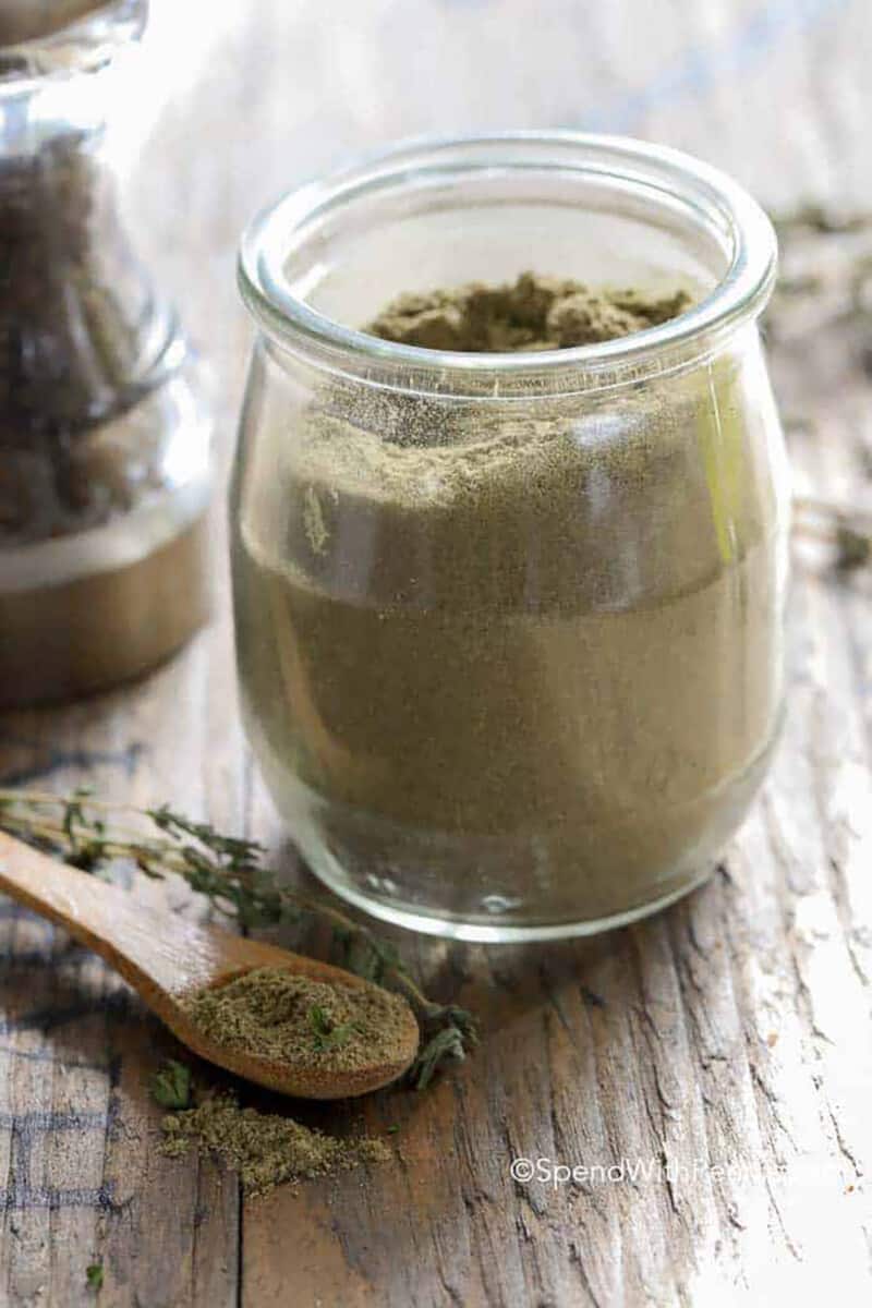 Poultry Seasoning in a glass jar and on a spoon