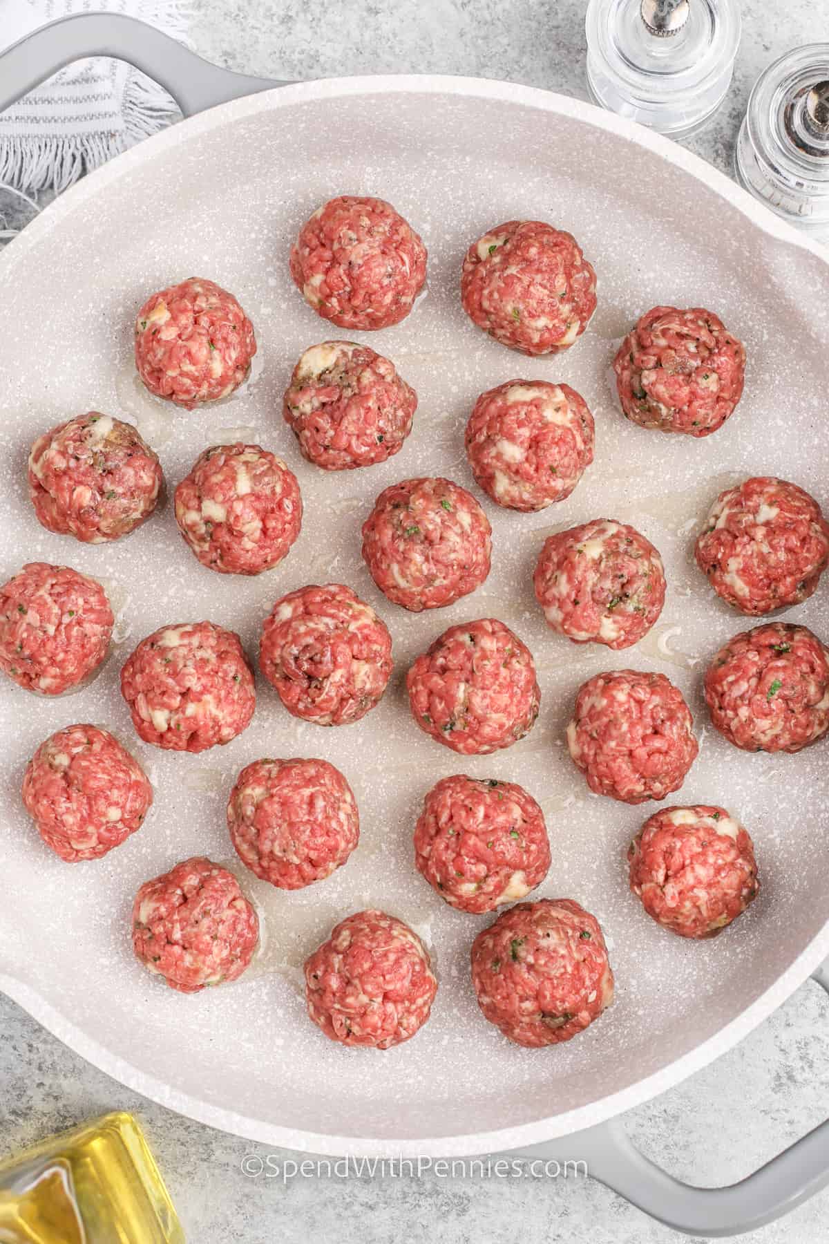 uncooked meatballs prepped on a plate
