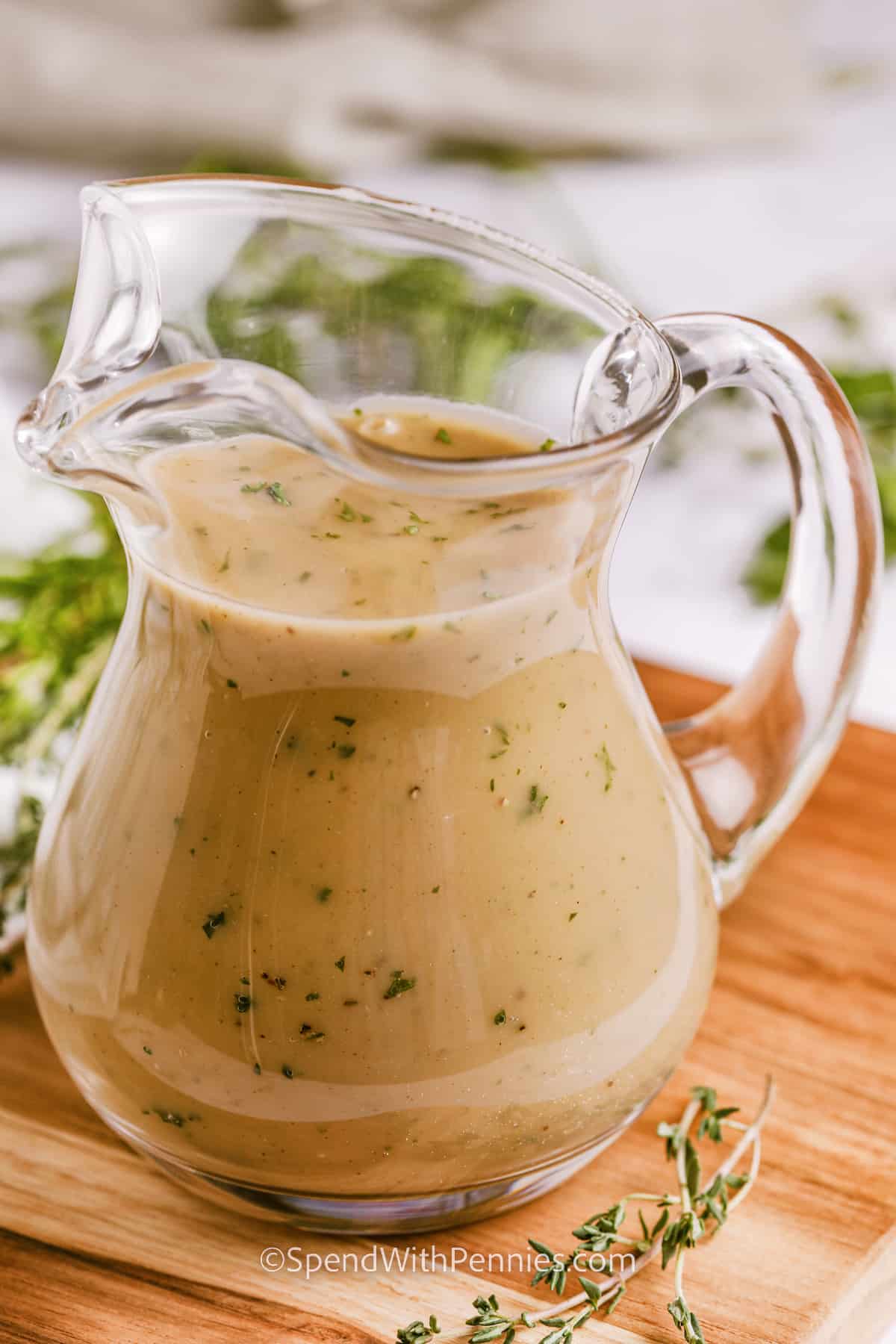 Learn how to make gravy with this easy method. This recipe will work with poultry like chicken or turkey or any meat that produces drippings, including roast beef. Just brown some flour with drippings and seasonings, then add liquid and thicken. Homemade gravy is easy and delicious! #howtomakegravy #howtomakegravyfromdrippings #homemadegravy #spendwithpennies gravy in a clear dish for How to Make Gravy