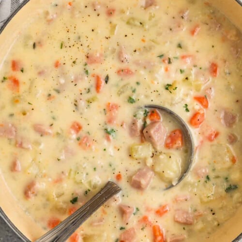 pot of Ham and Potato Soup with a spoon