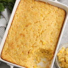 baked corn casserole in a white baking dish