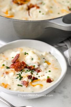 a bowl of creamy potato soup with bacon on top.