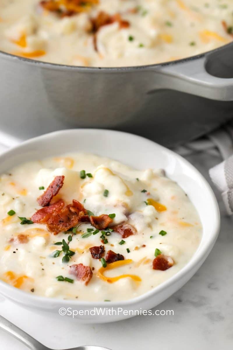 a bowl of creamy potato soup with bacon on top.