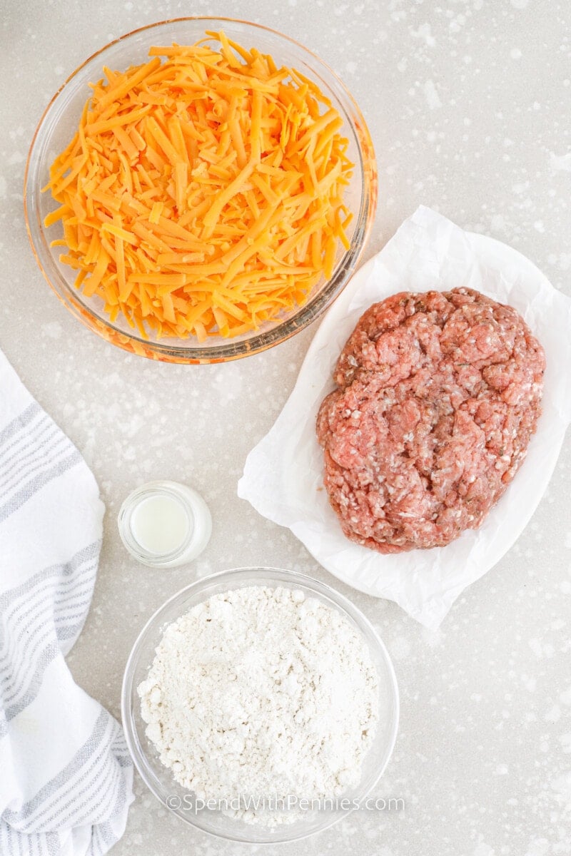 Give your taste buds a treat with these delectable sausage balls – a cheesy twist on the traditional meatball. You can even whip up a keto-friendly version! Featuring Bisquick mix, cheddar cheese, ground pork, and cream or milk, this recipe is bound to be a hit with your loved ones. #sausageballs #sausageballrecipe #appetizer #spendwithpennies ingredients to make Sausage Balls