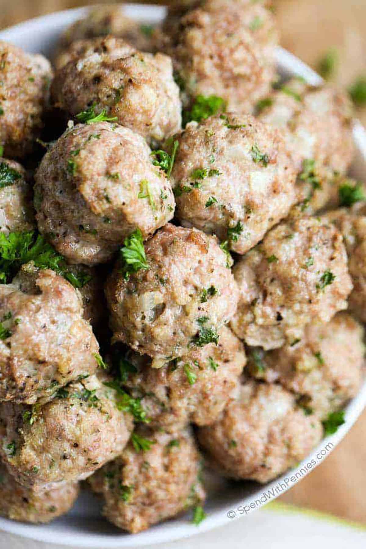 All-purpose turkey meatballs are a versatile and healthier alternative to traditional beef or pork meatballs. Made with lean turkey meat, they are delicious and nutritious! Enjoy them with pasta, in sandwiches, or as appetizers. These turkey meatballs are sure to please everyone’s taste buds! #turkeymeatballs #allpurpose #meatballs #spendwithpennies ground Turkey Meatballs in a bowl