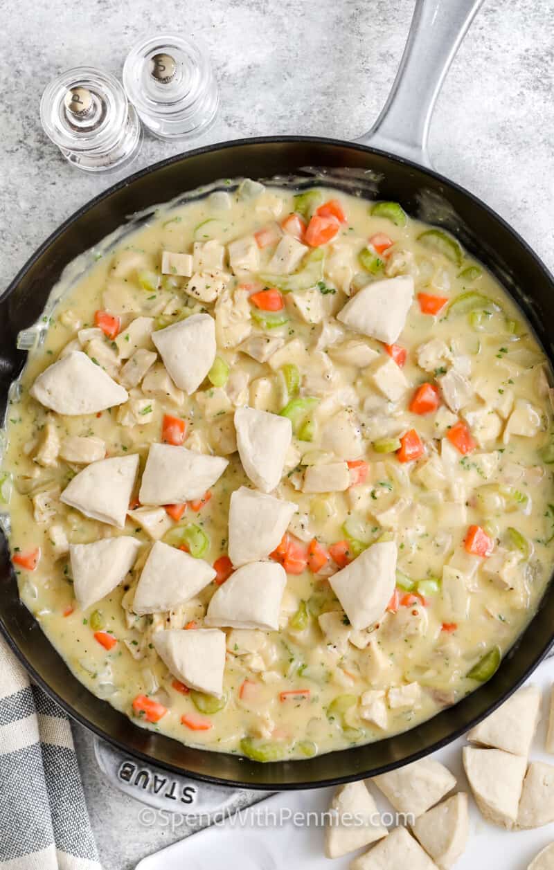 adding cream of chicken with biscuits to pan to make Chicken and Biscuits
