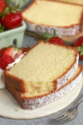 slices of pound cake on a plate next to strawberries