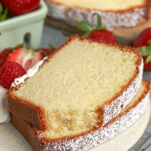slices of pound cake on a plate next to strawberries