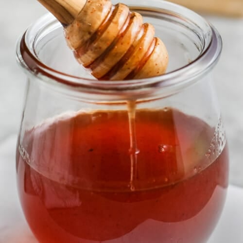 Hot Honey dripping from a honeycomb into a jar