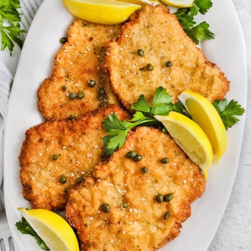 plated Schnitzel with lemon wedges