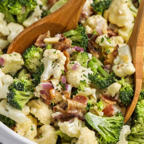mixing honey dijon dressing with Broccoli Cauliflower Salad