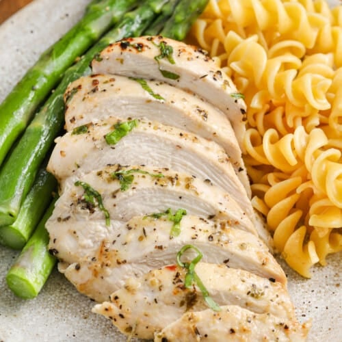 Italian Chicken Marinade on plated chicken with noodles and asparagus