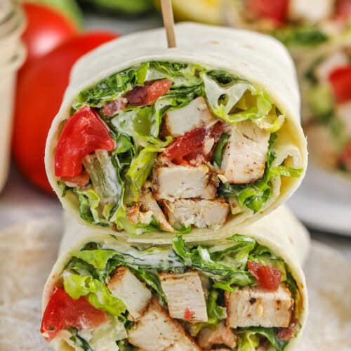 Chicken Caesar Wrap cut in half on a plate with a toothpick