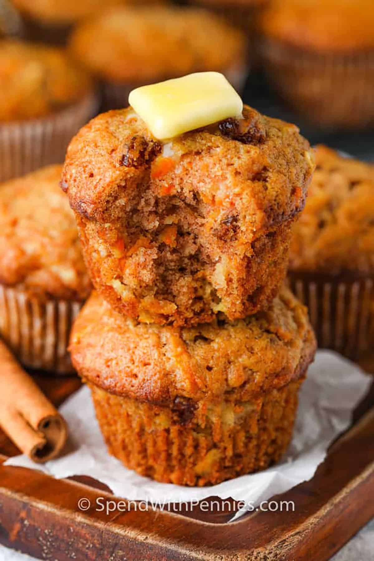 Carrot Muffins with a bite taken out and butter