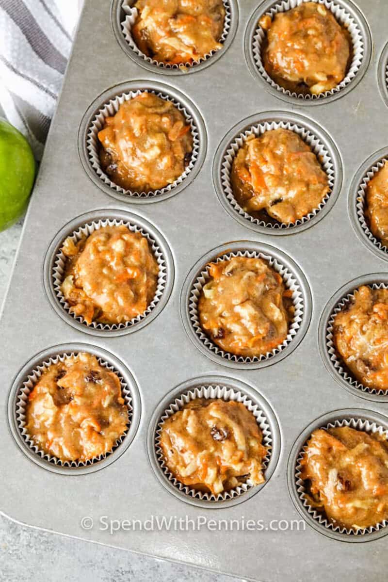 adding Carrot Muffins batter to a muffin tin