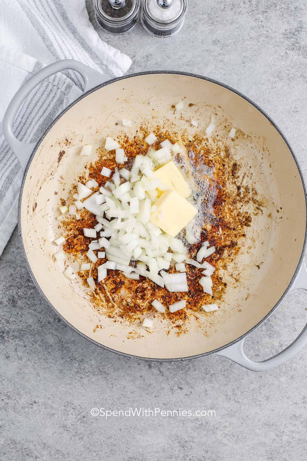 Onions and butter in a pot with fond under it for beef stroganoff
