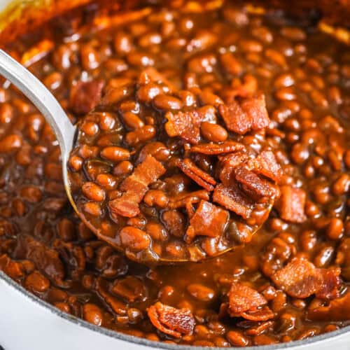 taking a spoonfull of The Best Baked Beans out of the pot