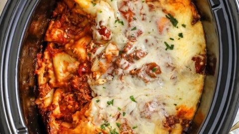 cheesy Crock Pot Lasagna with a portion taken out of the pot