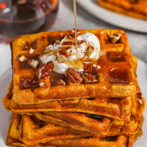 pouring syrup over Pumpkin Waffles