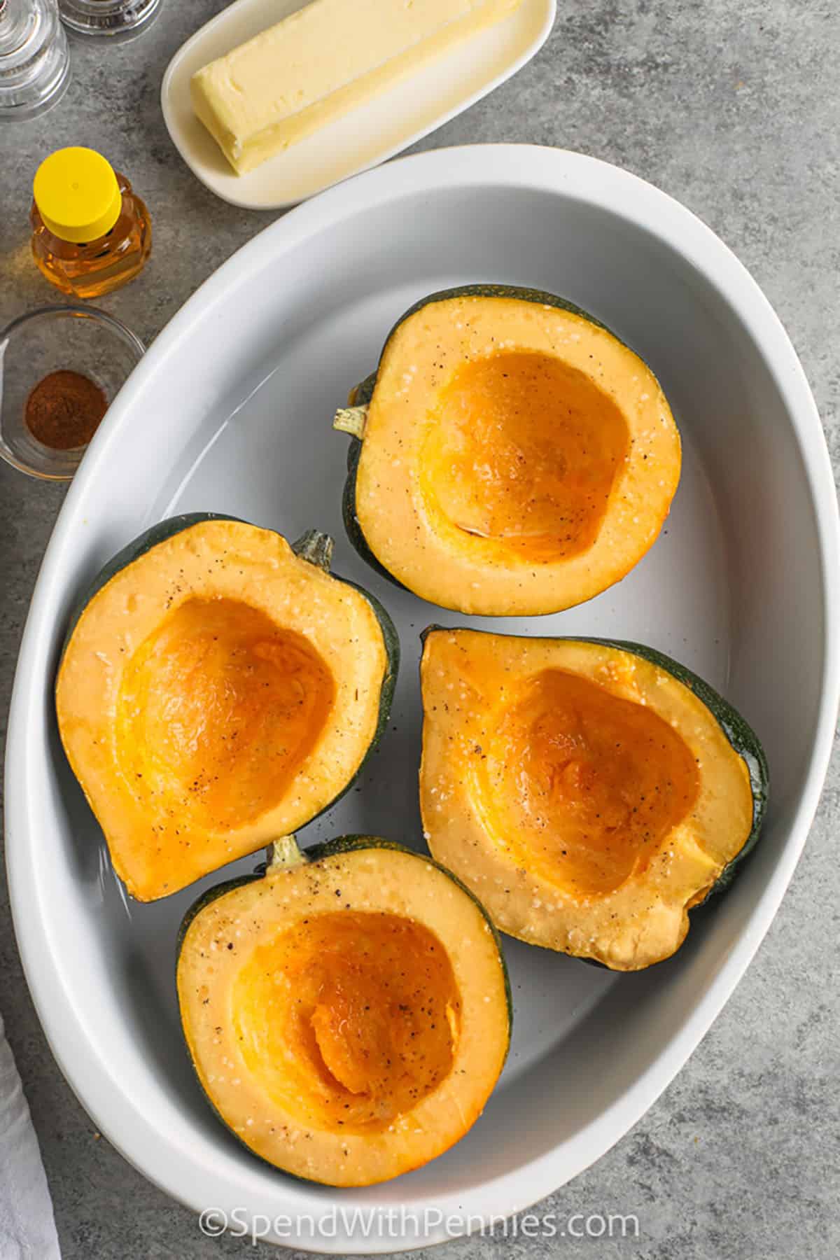 adding seasoned squash to pan to make Roasted Acorn Squash