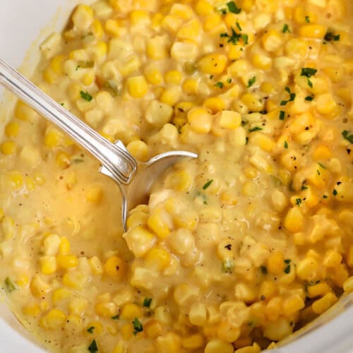 Crock Pot Creamed Corn in the pot with a spoon