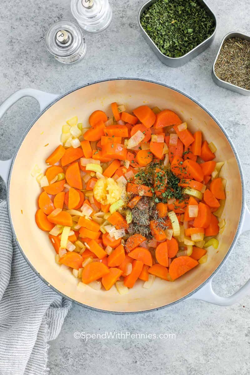 cooking carrots in a pot for chicken for chicken and rice soup.