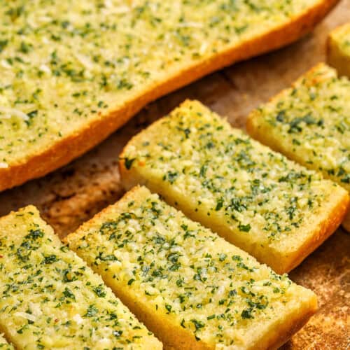 Homemade Garlic Bread cut into slices on a sheet pan