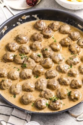 a skillet of cooked Swedish meatballs in sauce