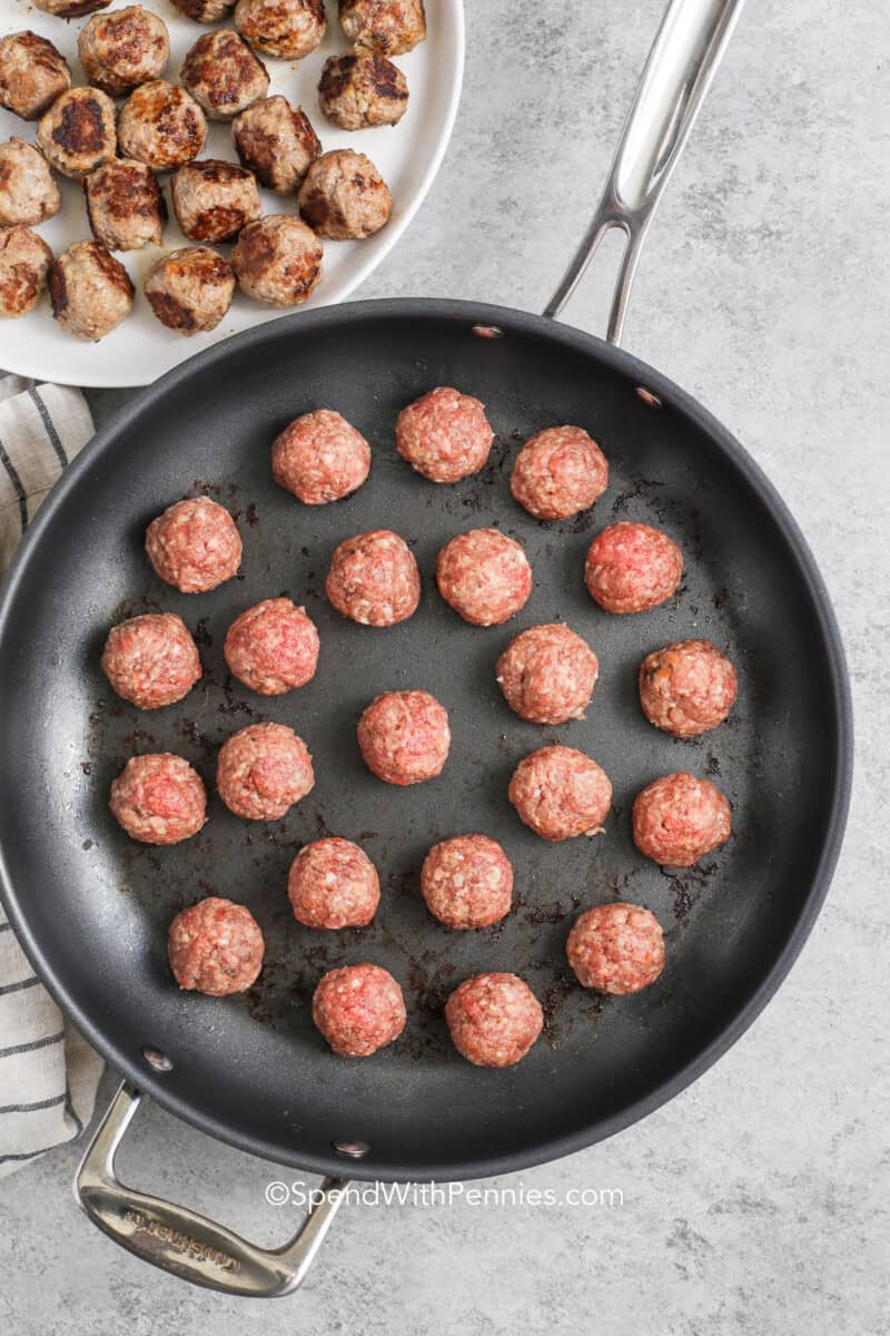 raw Swedish meatballs rolled and in a skillet