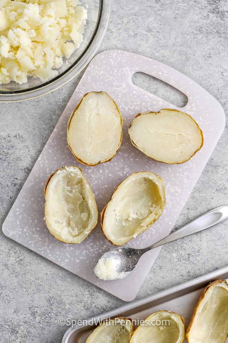 scooping out potatotes out of the shell to make Twice Baked Potatoes