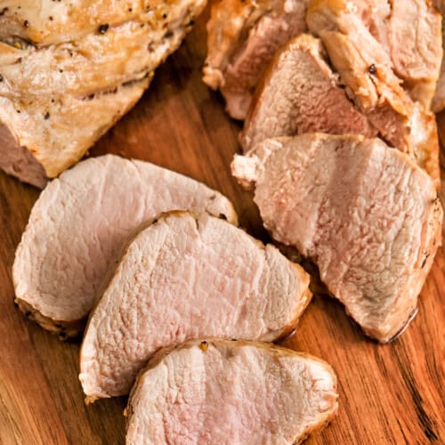 sliced Pork Tenderloin on a cutting board to show How to Cook Pork Tenderloin