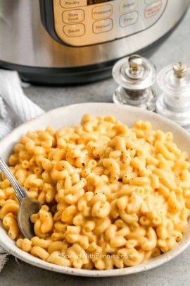 instant pot mac and cheese being in a bowl with a spoon
