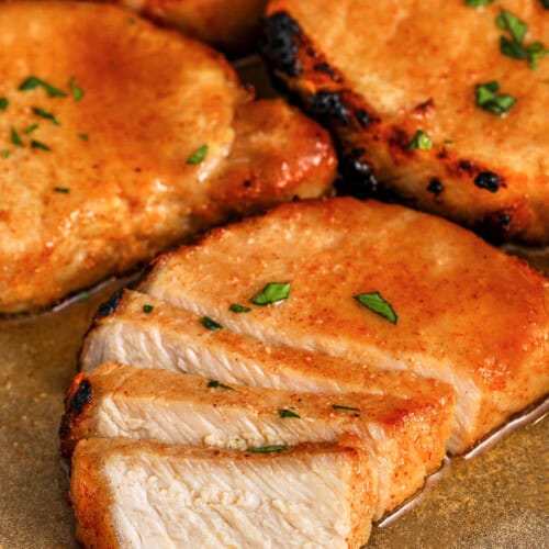 plated Juicy Baked Pork Chops with one cut into slices