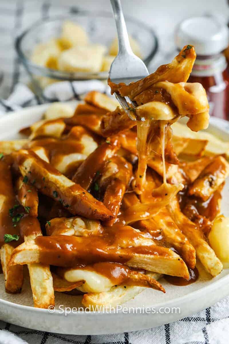 plated Homemade Poutine with some on a fork