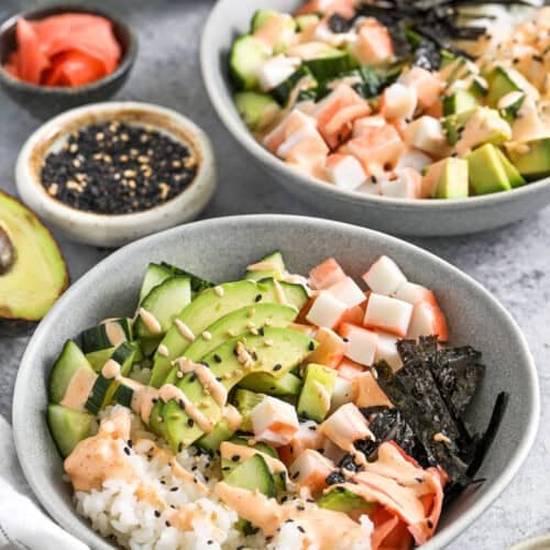 bowls of California Roll Sushi Bowl with dressing over top
