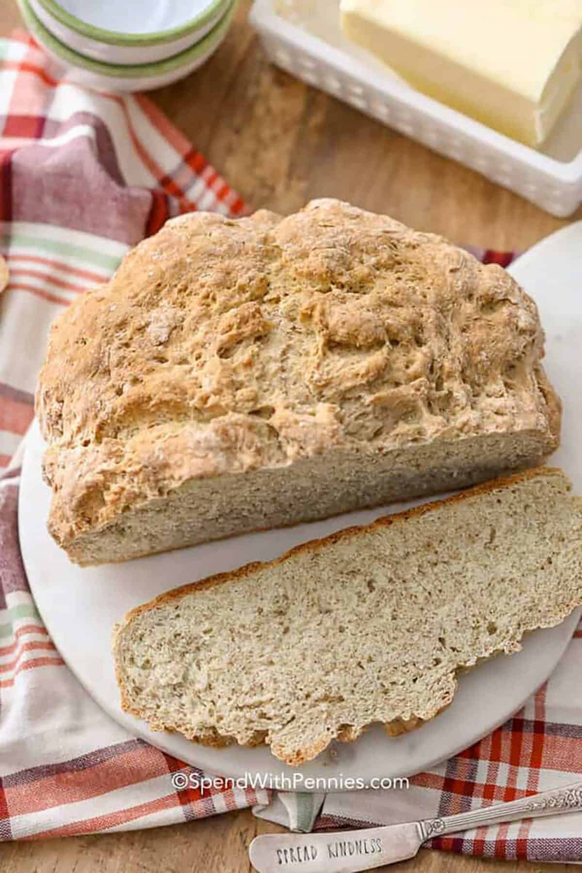 A cut loaf of Irish soda bread on a white plate