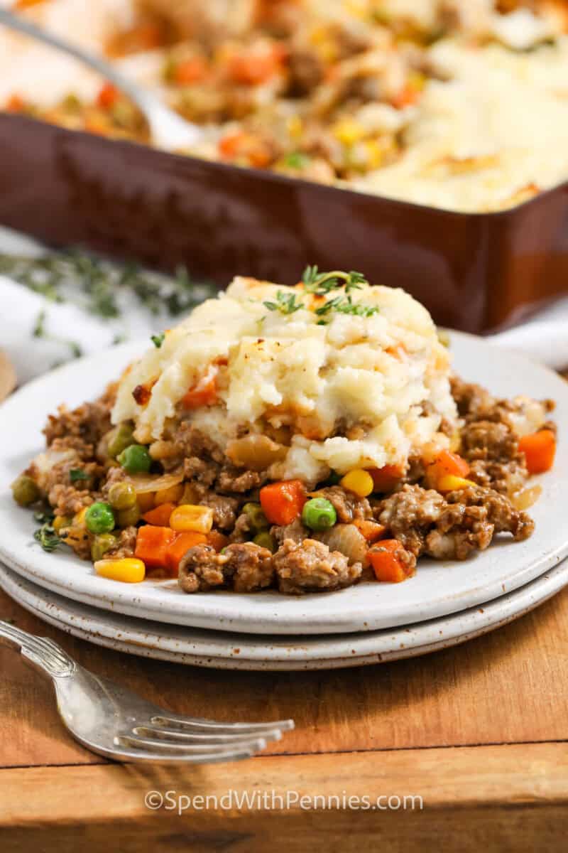 Shepherd's Pie in a plate and dish full in the background