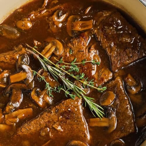 Round Steak and Mushrooms in a pot with gravy