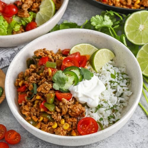 bowls of Ground Turkey Burrito Bowls with sour cream